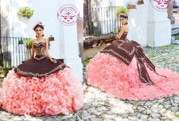 A woman in a pink and brown charro Quinceañera dress sitting on a bench