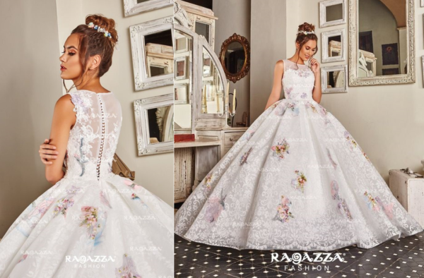 A woman in a Quinceanera gown standing in front of a mirror