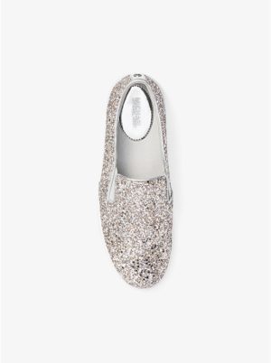 A pair of silver glitter trainers on a white surface for a Quinceanera