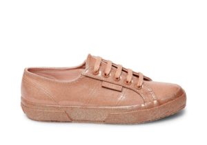 A close up of a tan shoe on a white background for a Quinceanera