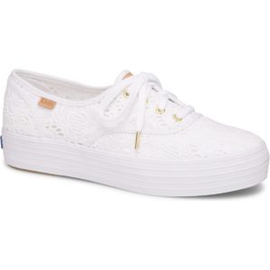 A white women's walking shoe on a white background