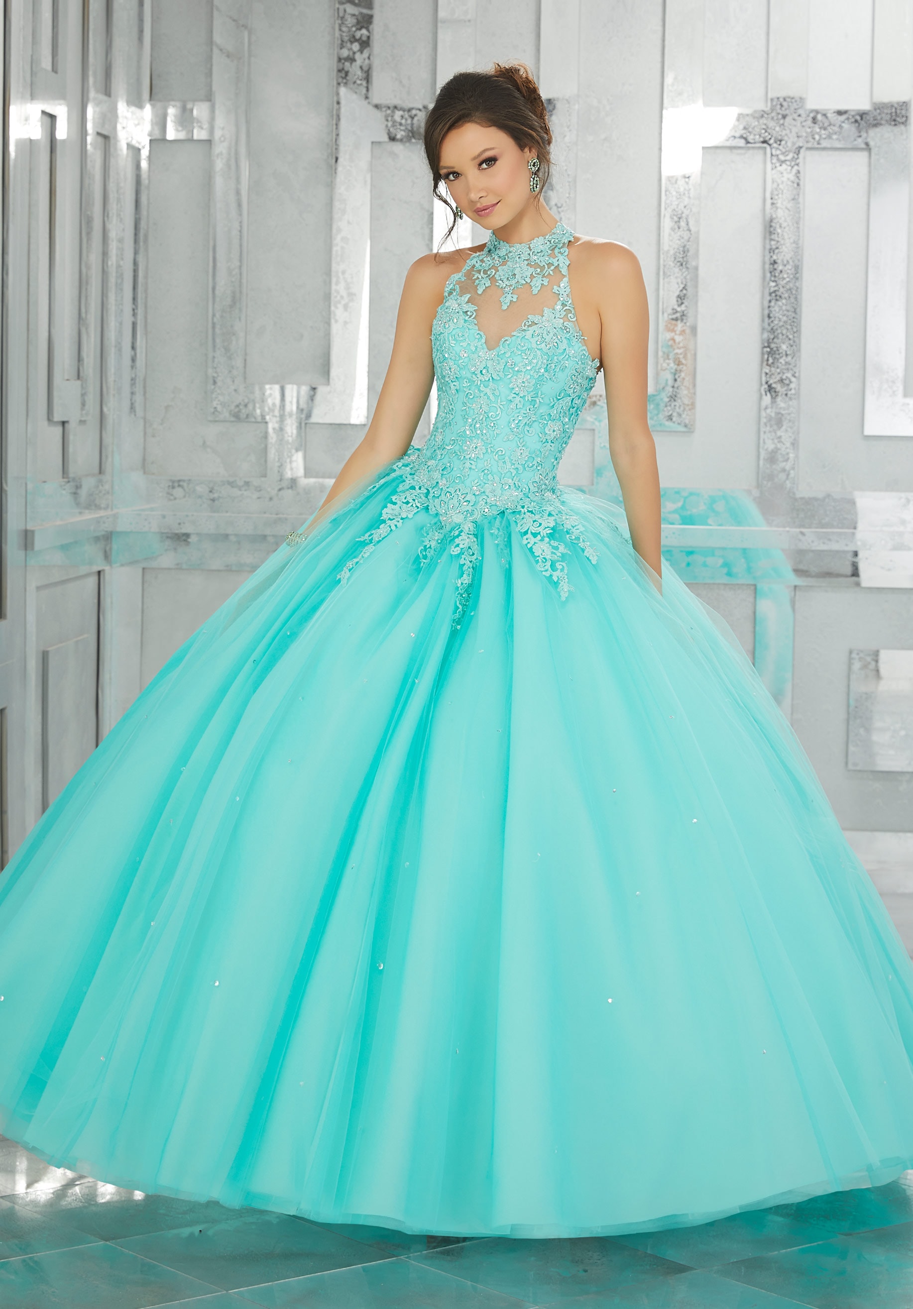 Quinceañera dresses: a woman in a turquoise dress posing for a picture