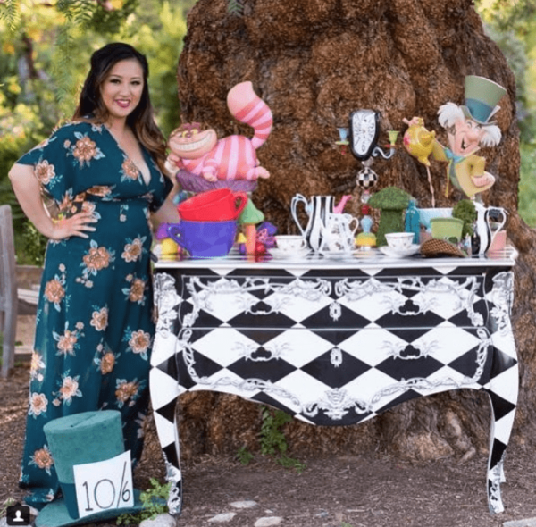 Quinceanera party planning, a woman standing in front of a table with decorations on it