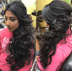 A woman with long black hair in a salon, showcasing one of the 15 most traditional quinceanera hairstyles ever.