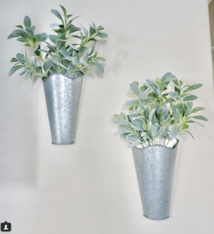 A flowerpot with a couple of potted plants on a wall, perfect for a Quinceanera celebration.