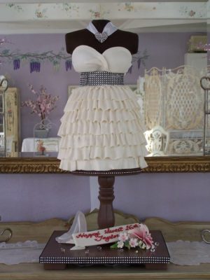 A mannequin wearing a Quinceanera gown on a table