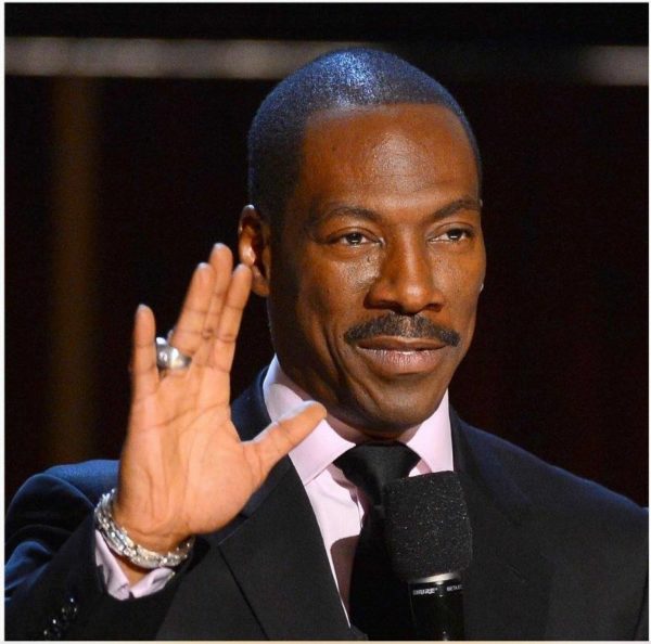 Eddie Murphy, a close up of a person holding a microphone, in a Quinceanera setting
