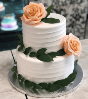 Quinceanera cake, a three tiered cake with roses on top of it