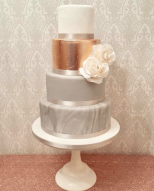 Quinceanera cake, a three tiered cake with a rose on top