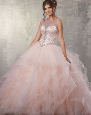 Quinceanera gown - a woman in a pink dress posing for a picture