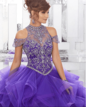 A woman in a purple Quinceanera gown posing for a picture