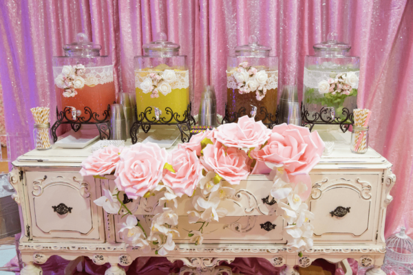 A beautiful Quinceanera floral arrangement featuring a bouquet of flowers and a table decorated with vases filled with flowers.