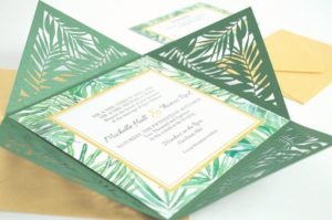 A Quinceanera invitation, featuring a green and gold tropical theme