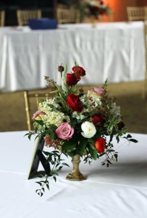 Floral design with a table featuring a vase of flowers, perfect for Quinceanera