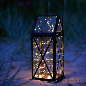 A beautifully lit lantern with fairy lights, creating a festive and magical atmosphere for a Quinceanera celebration.