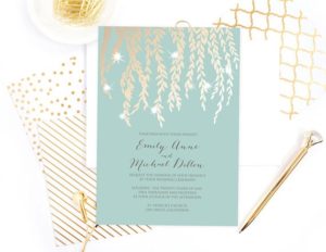 A Quinceanera invitation on a table with gold foil