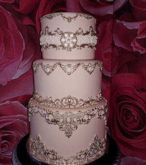 A three-tiered Quinceanera cake sitting on top of a table