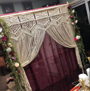 A Quinceanera-themed image depicting a room with a table and a curtain