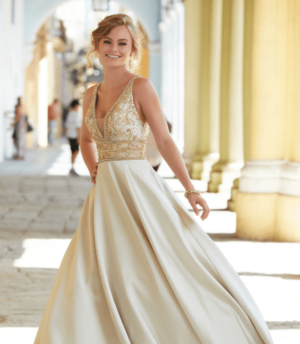 A Quinceanera wearing a gown designed by Novias Ursula Escoriza walking gracefully on a street