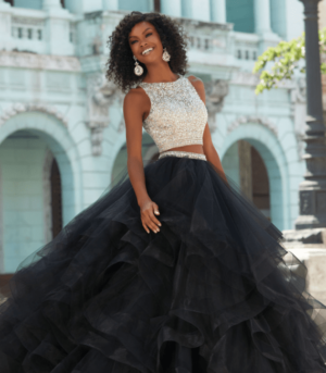 Quinceanera gown, a woman in a black and white dress standing in front of a building