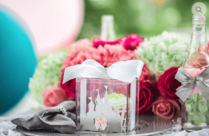 A Quinceanera-themed centerpiece featuring a glass vase filled with flowers