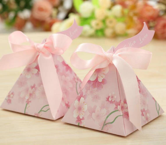 Quinceanera favors: A couple of pink boxes sitting on top of a table