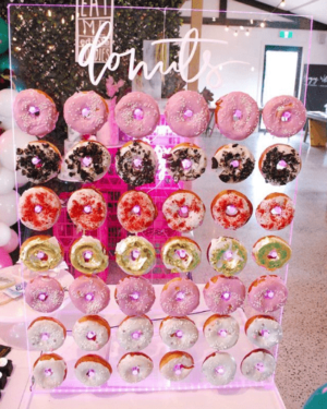 A display of doughnuts on a table at a Quinceanera event