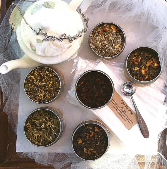 A variety of teas and teapots on a table at a Quinceanera celebration