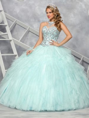A woman wearing a Quinceañera gown posing for a picture