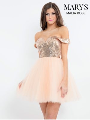 Quinceanera: A woman in a cocktail dress posing for a picture