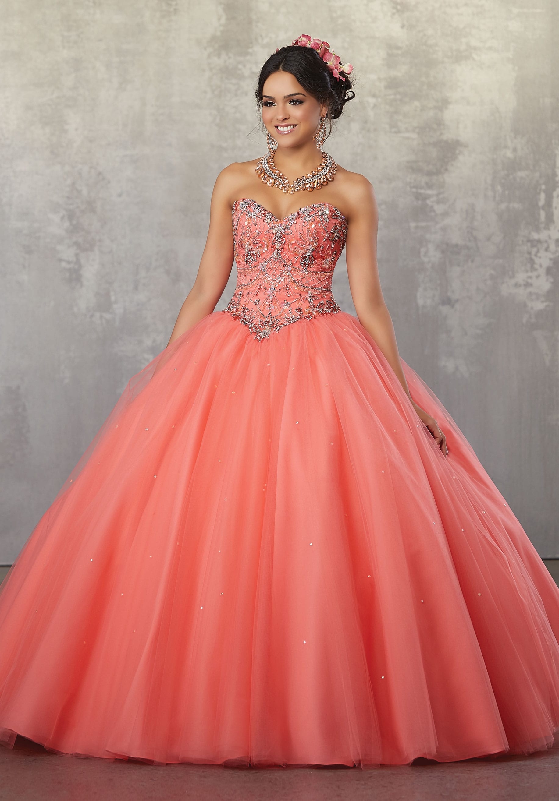 A woman in a ball gown posing for a picture wearing Quinceañera dresses