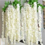 Quinceanera image with wisteria artificial flowers hanging from the ceiling and a bunch of white flowers