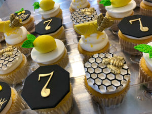 A table topped with Quinceanera themed cupcakes covered in buttercream frosting