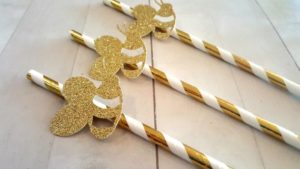 Gold, a group of gold and white straws sitting on top of a table