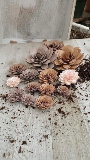 A pile of paper flowers sitting on top of a wooden table at a Quinceañera
