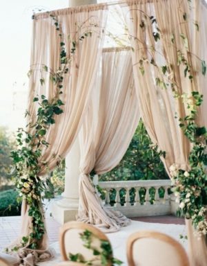 An outdoor Quinceanera ceremony at Edelweiss wedding hall with a canopy and draping