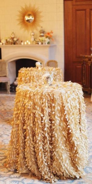 A Quinceanera-themed living room with a fireplace and a table covered in hay