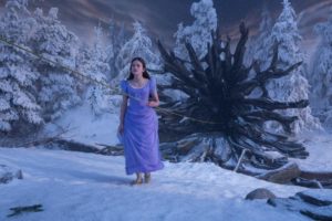 Mackenzie Foy, a woman in a purple dress standing in the snow holding Clara the Nutcracker and the Four Realms