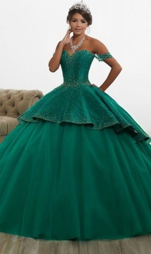 A woman in a green ball gown posing for a picture, wearing a quince dress for morenas