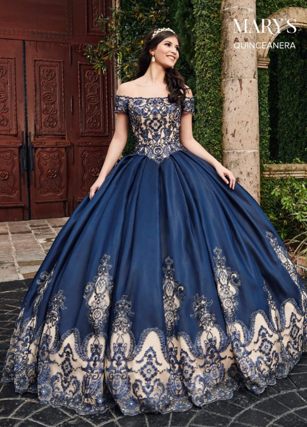 A woman wearing a navy blue and gold ball gown, perfect for Quinceanera.