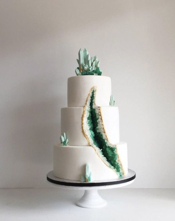 Quinceanera cake featuring a geode design, with a white base and a green agate slice on top