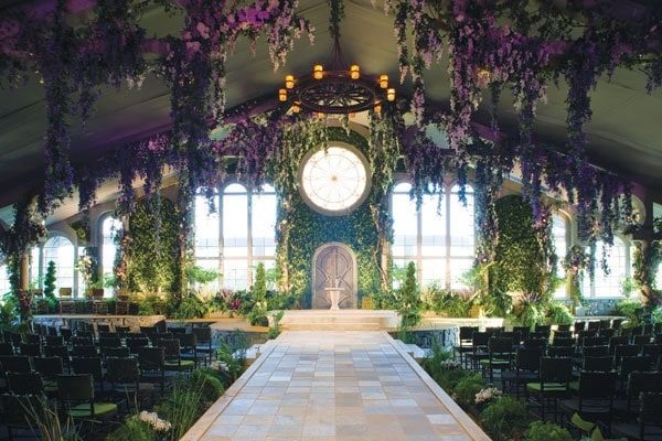 A Quinceanera celebration in a beautifully decorated castle, surrounded by a magical forest