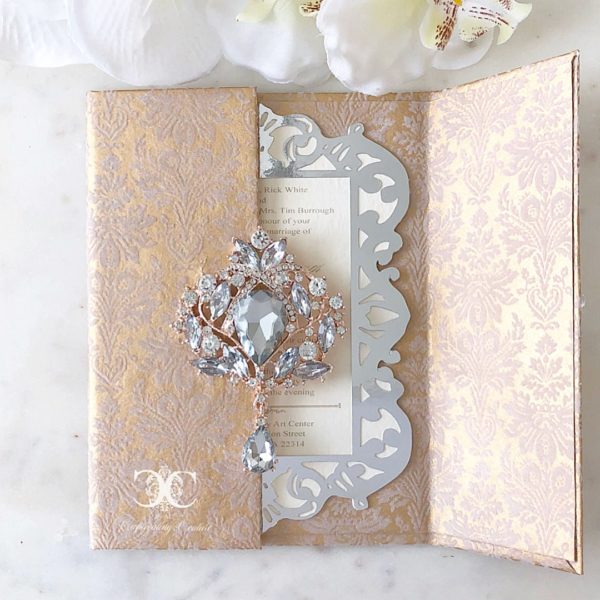 A close up of a book with a brooch on it, perfect for a Quinceañera celebration