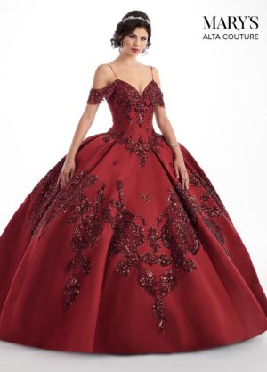 Quinceanera dress designs - A woman wearing a red ball gown