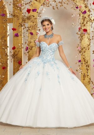 A woman in a white and blue ball gown for a Quinceanera event