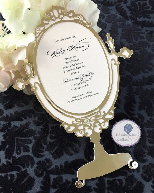 A picture of a Quinceañera invitation surrounded by jewellery on a table
