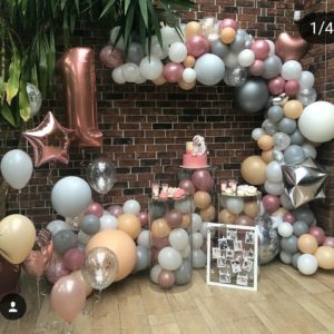 A Quinceanera birthday party with a rock garden and balloons, featuring a cake