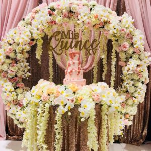 Quinceanera floral design, a table topped with a cake covered in flowers