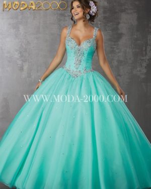 A woman in a turquoise ball gown, wearing Quinceañera dresses