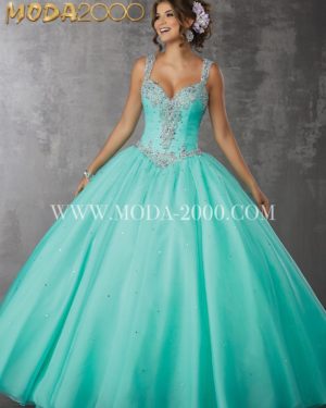 A woman in a turquoise ball gown, wearing Quinceañera dresses